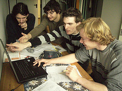 Teilnehmer an der Mathenacht über einen Laptop gebeugt